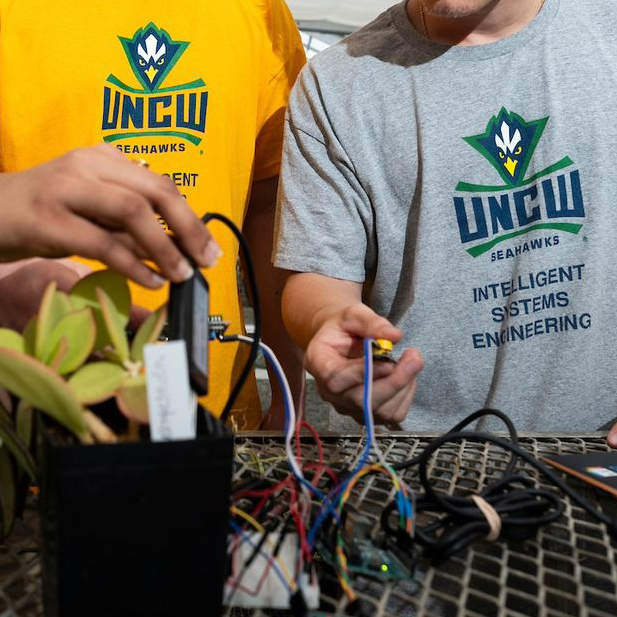 Image of UNCW students working with wires.